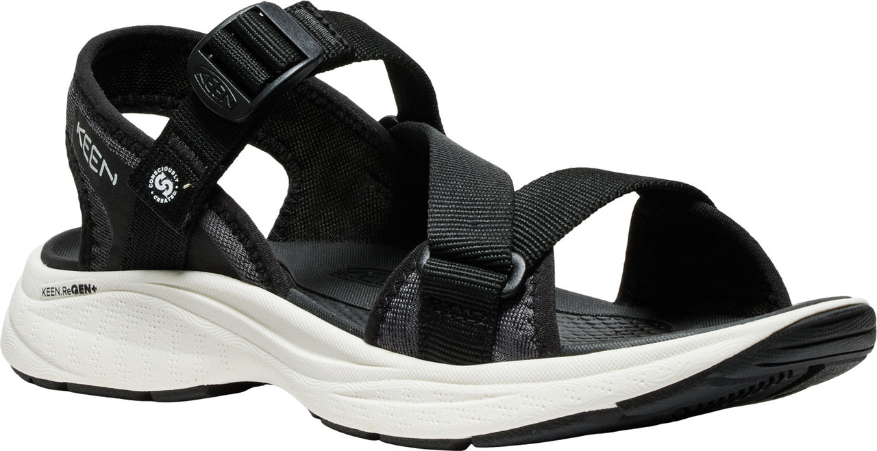 Black sandal with adjustable straps, white midsole and black outsole.