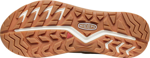 A shoe sole with deep brown lug pattern interspersed with white.