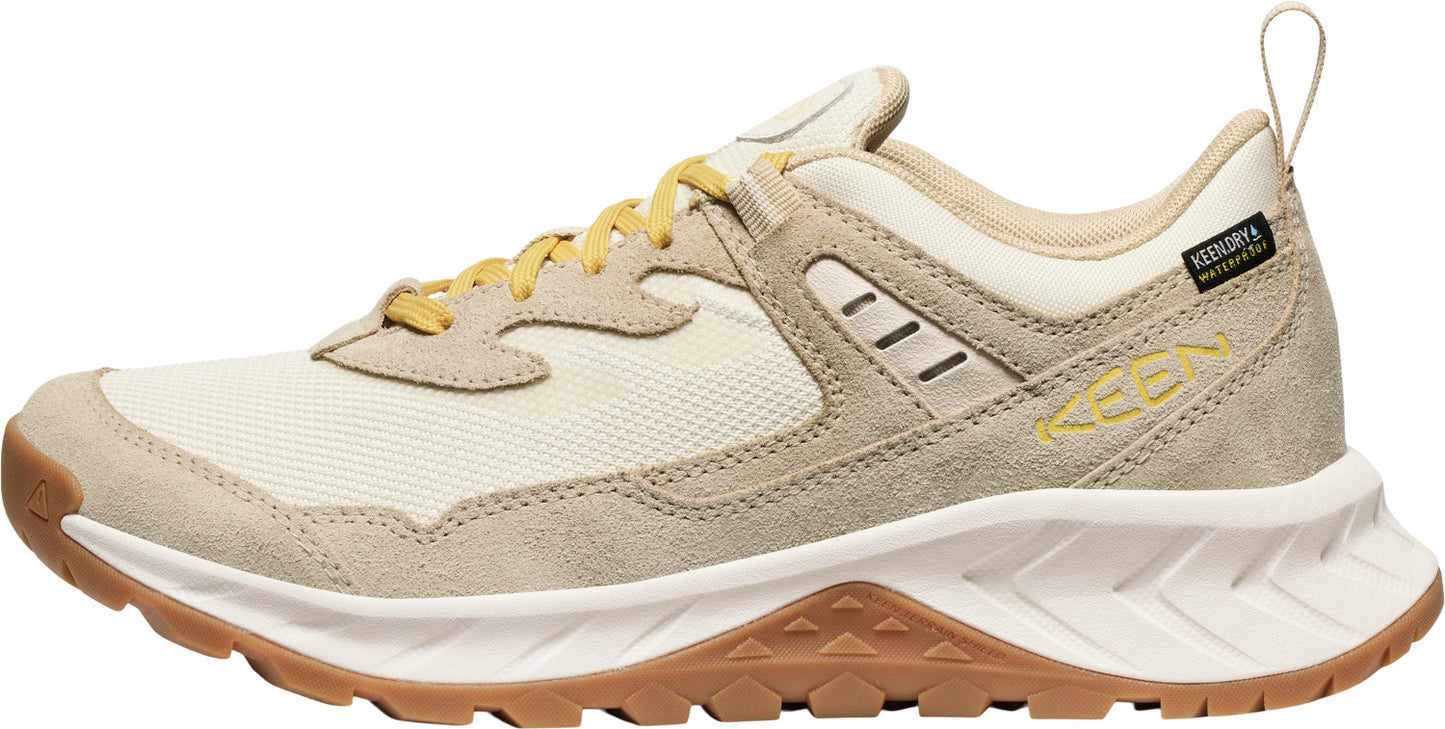 Beige hiking shoe with yellow laces and brown sole.
