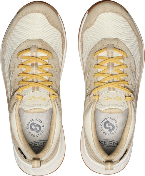 Top view of two light tan KEEN sneakers with yellow laces.
