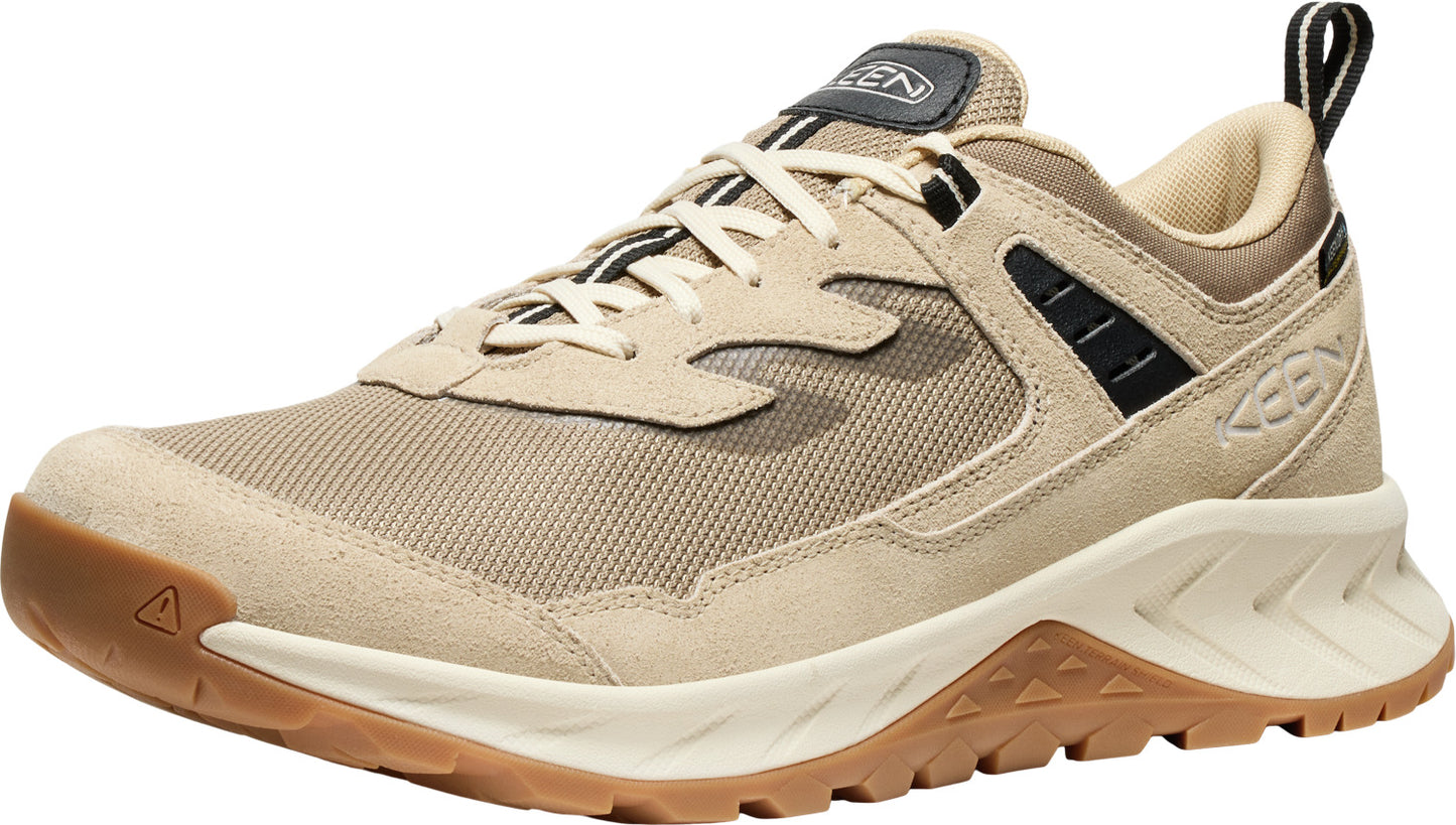 Tan low top athletic shoe with a brown rubber sole and laces.