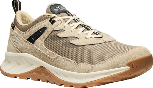 Beige running shoe with suede accents, rubber sole, and black pull tab.