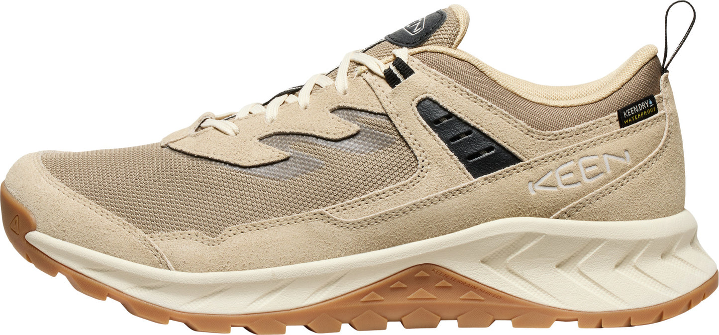 A tan-colored low-top hiking shoe with brown soles and black accents.