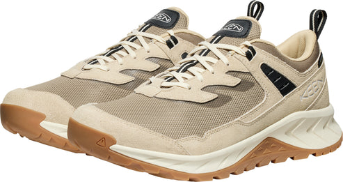 Tan athletic shoes with white laces and tan treaded soles.