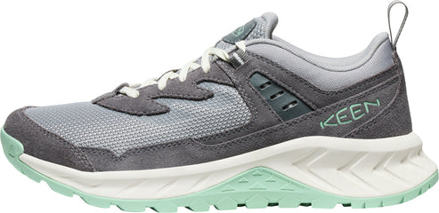 A gray hiking shoe with white laces and a green sole.