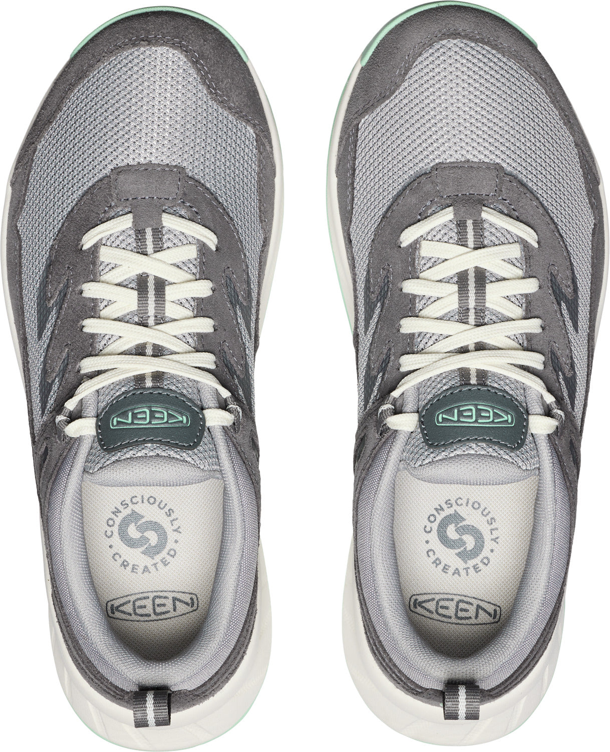 A pair of gray and white sneakers with mesh and suede paneling and white laces.