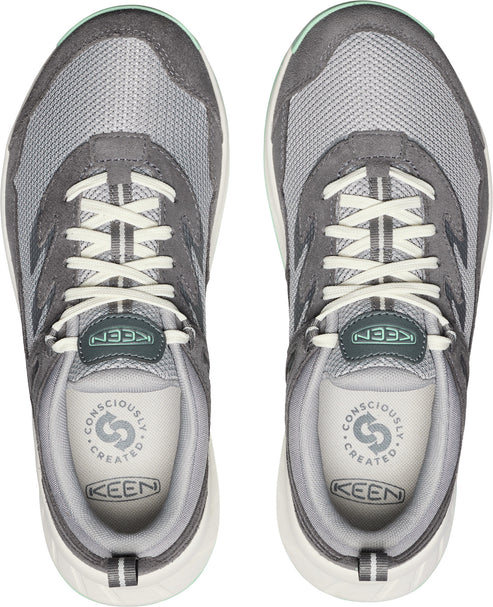 A pair of gray and white sneakers with mesh and suede paneling and white laces.