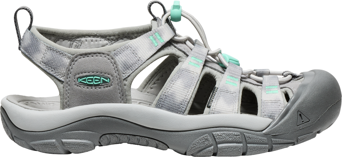 A gray sandal with a closed toe and teal accents.