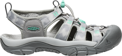 A gray sandal with a closed toe and teal accents.