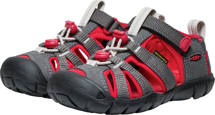 Pair of gray and red water sandals with a hook and loop strap.