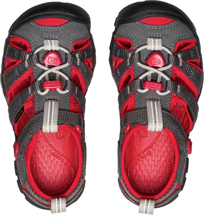 Overhead view of a pair of gray and red closed-toe sandals with a lace-up closure.
