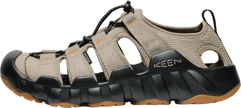 A Keen sandal with a taupe upper and black and brown sole.