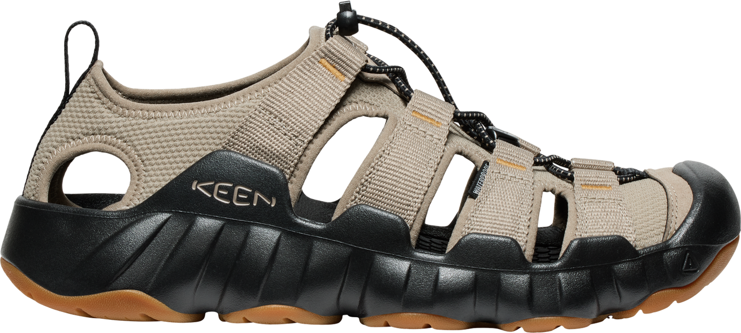 A sandal with a brown upper, a black midsole, and a brown sole.