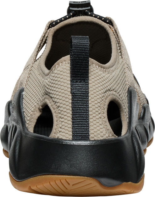 Rear view of tan textured shoe with black sole and pull tab.