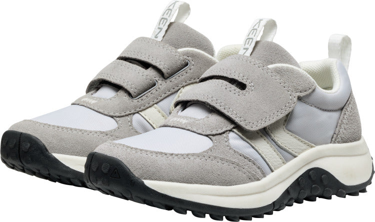 A pair of gray and white sneakers with black soles and velcro straps; the name "KEEN" is vertically printed on the tongue.