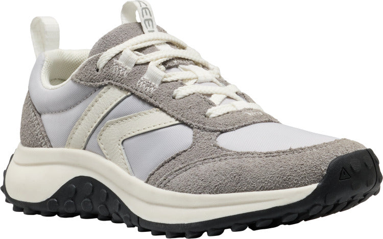 A low-top athletic shoe with gray suede and white nylon panels, white laces, a thick black and off-white sole, and a white heel pull tab.