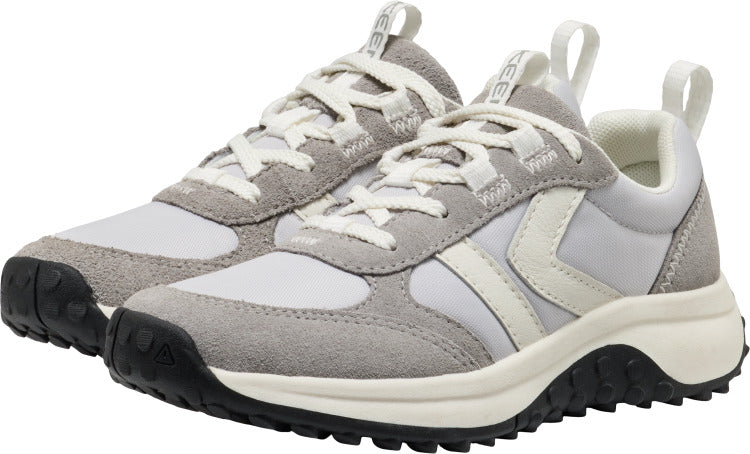 A pair of white and grey athletic shoes with a white logo on the side, white laces, and black soles.