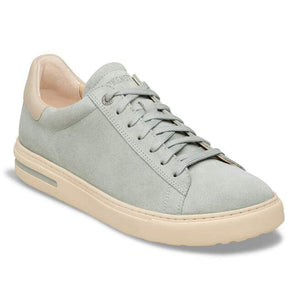 Low profile sneaker with light blue suede and tan sole and heel.