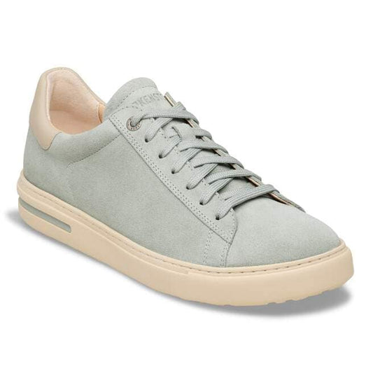 Low profile sneaker with light blue suede and tan sole and heel.