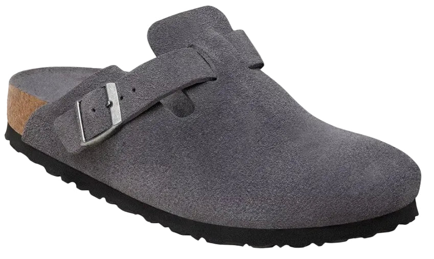 A gray suede mule-style shoe with an adjustable metal buckle strap, a cork-textured footbed edge, and a black, ridged rubber sole.