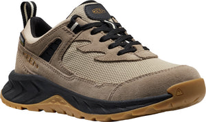 A beige and black athletic shoe with a brown sole.