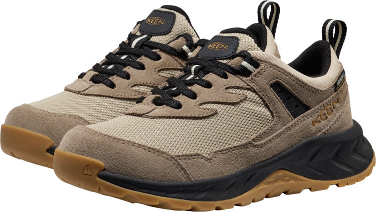 A pair of beige casual sneakers with black laces, a black and tan sole, and a heel loop.