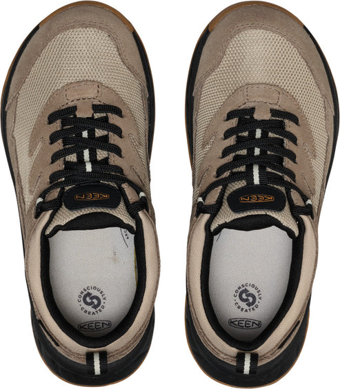 Top-down view of two tan sneakers with black laces and white insoles.