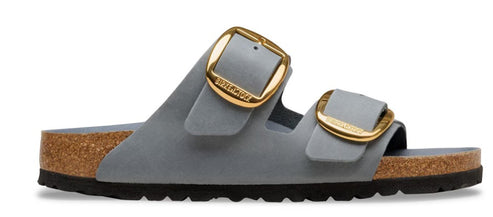 Gray slide sandal with cork footbed and oversized gold buckles on straps.