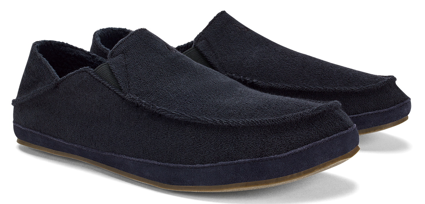 Two black slip-on shoes with brown soles.