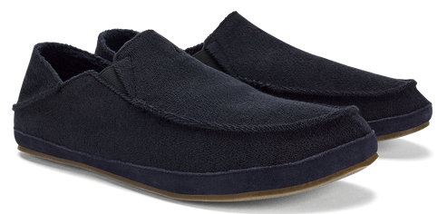 Two black slip-on shoes with brown soles.