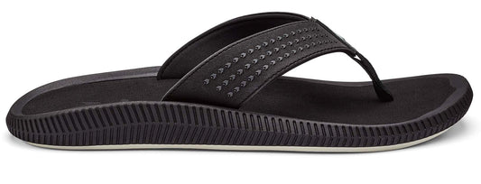 Black sandal with textured footbed and strap.