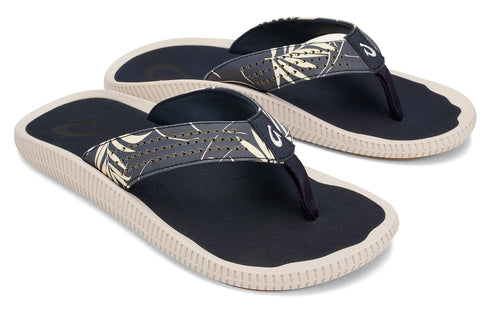 Two navy flip-flops with floral print straps and tan soles.