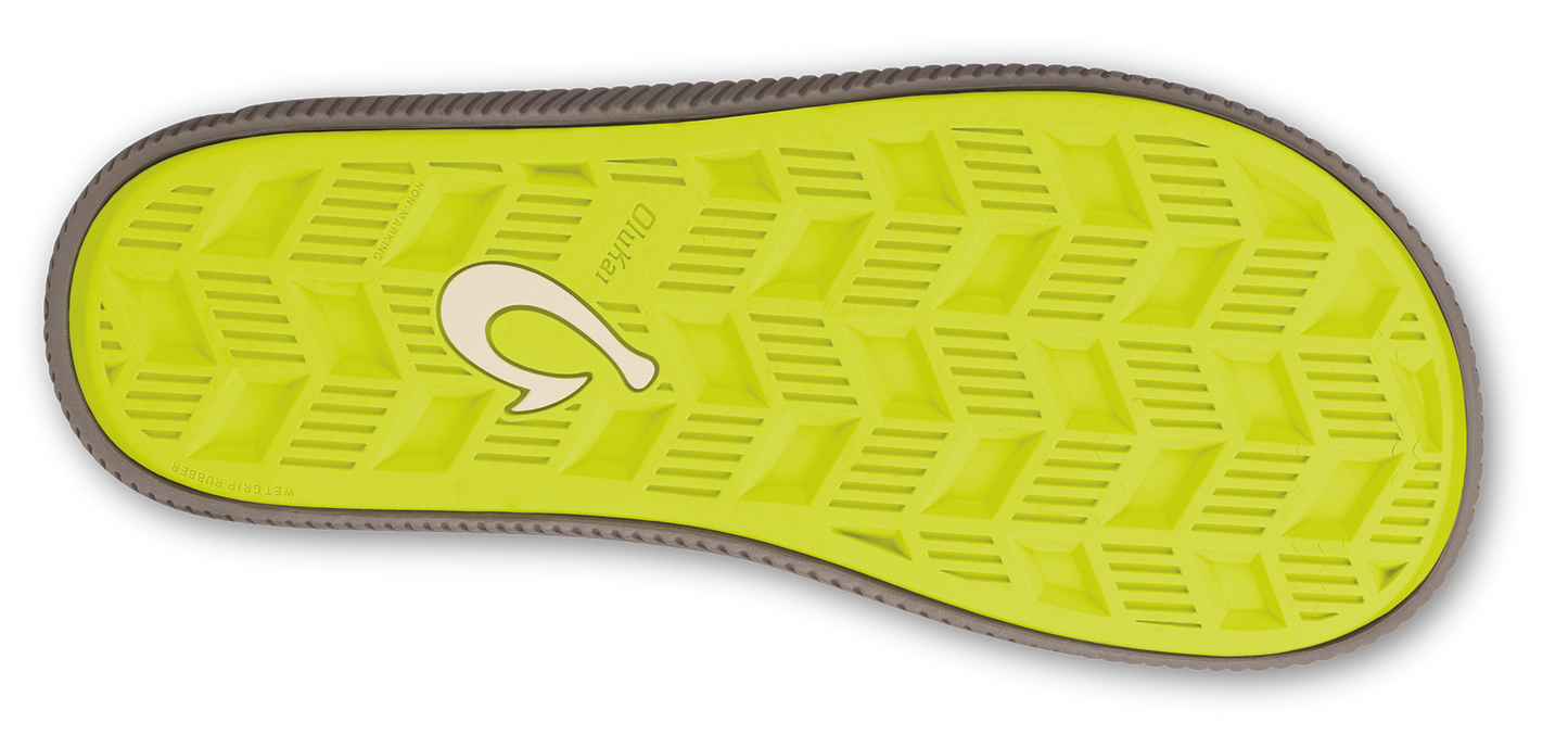 A flip-flop sole with green and triangular patterns.