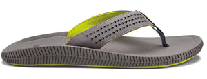 A grey flip-flop with a neon green lining and black toe thong.