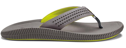 A grey flip-flop with a neon green lining and black toe thong.