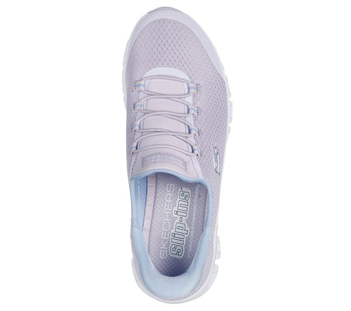 Top-down view of a lavender slip-on sneaker with light blue interior, light gray laces, and the words "SKECHERS SLIP-INS" on the insole.