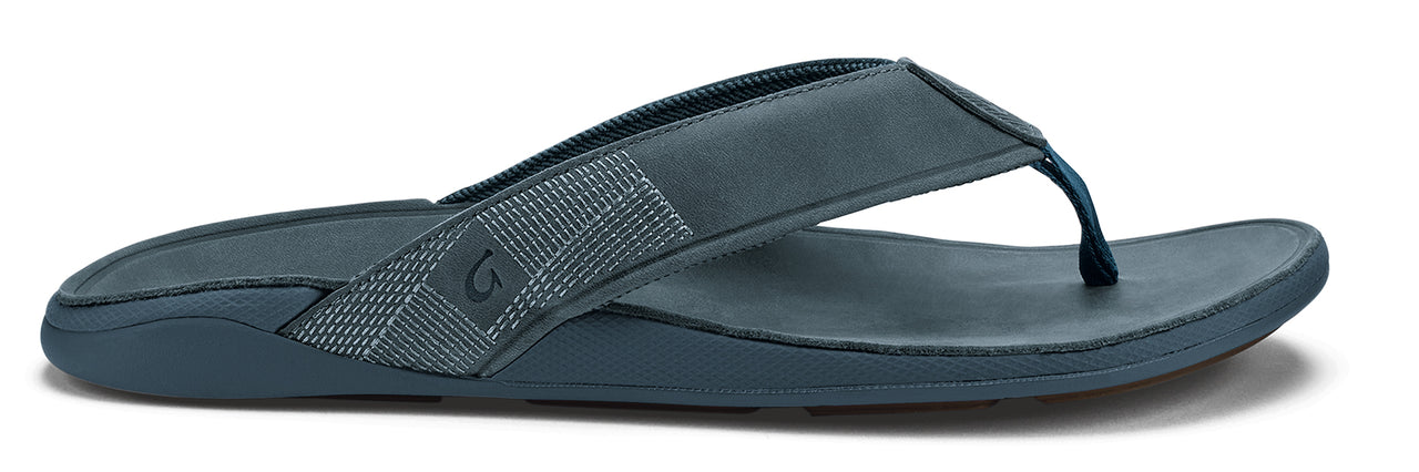 Dark blue flip-flop with fabric strap.
