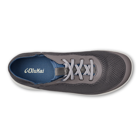 Overhead view of a gray sneaker with gray laces and a white sole. The insole is blue with white text that reads 'Olukai'.