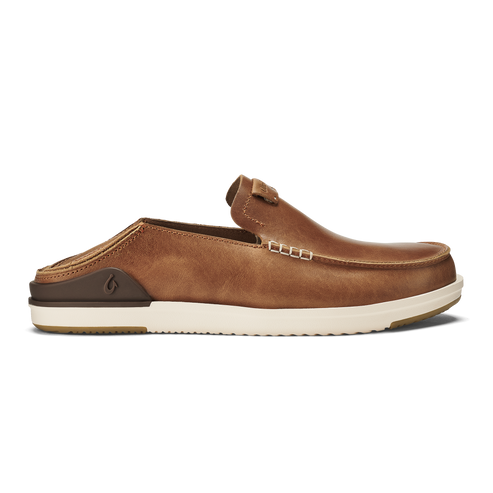 A tan brown leather slip-on mule shoe with a collapsible heel, visible decorative side stitching, and a thick, white ridged rubber sole featuring a dark brown heel accent with an embossed logo.