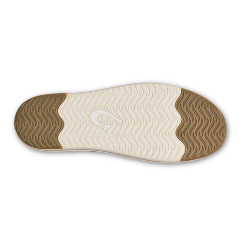 The underside of a sneaker sole featuring a wavy textured pattern at the heel and toe, with a central area displaying a wave-like graphic in the middle of a cream-colored traction surface.