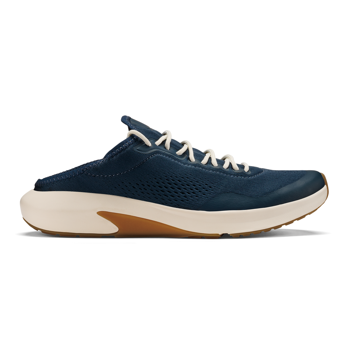 A slip-on sneaker in dark navy blue with a breathable perforated upper, off-white laces, and a thick off-white midsole with a gum-colored rubber insert at the heel.