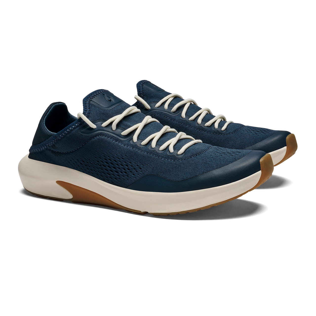 A pair of navy blue athletic sneakers with cream-colored laces and a white midsole with a gum rubber outsole, viewed from a three-quarter angle.