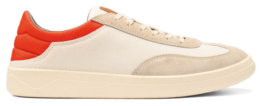 A low-top off-white sneaker with an orange heel.