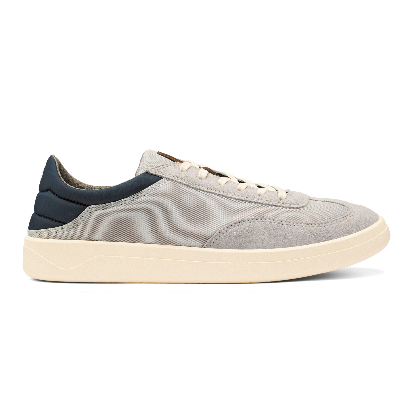 A casual sneaker with a grey fabric and suede upper, a navy blue heel panel, cream-colored laces, and a thick cream-colored flat rubber sole.