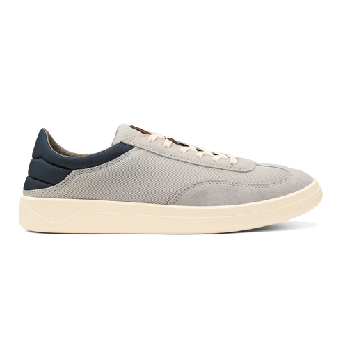 A casual sneaker with a grey fabric and suede upper, a navy blue heel panel, cream-colored laces, and a thick cream-colored flat rubber sole.