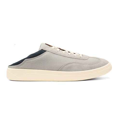 A light grey slip-on sneaker with a dark navy heel collar, white laces, and a thick cream-colored rubber sole against a plain background.