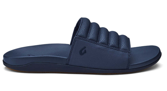 Navy-blue slide sandal with horizontal quilted strap.