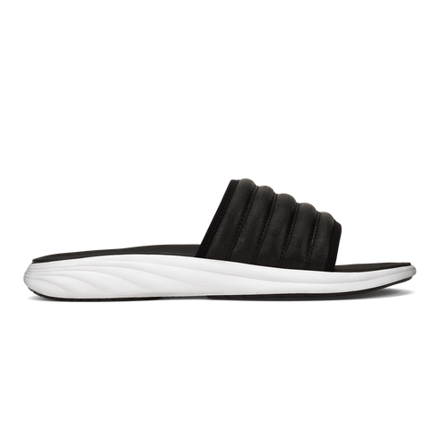 Black slide sandal with a ribbed upper and white sole.