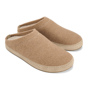 A pair of tan, slip-on felt slippers with a light beige, smooth rubber-like trim around the sole and a plush lining visible at the heel.