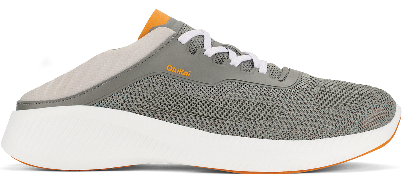 A gray slip-on sneaker with white laces, a white sole, and orange accents.